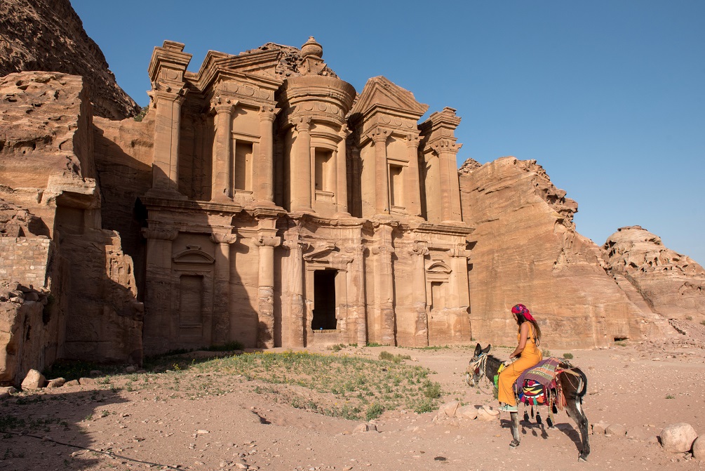 Traveler woman riding donkey in Petra, Jordan