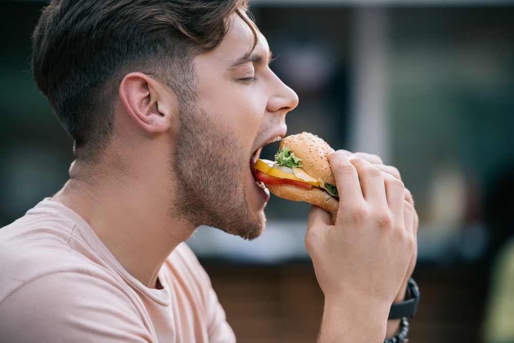 man eating tasty burger