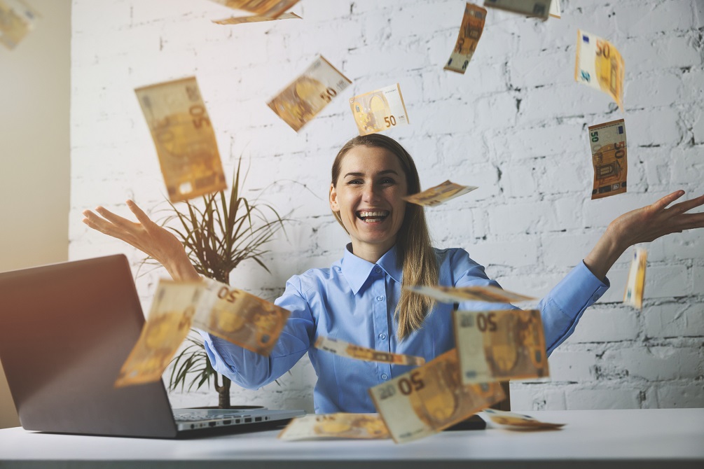 woman throwing euro banknotes 