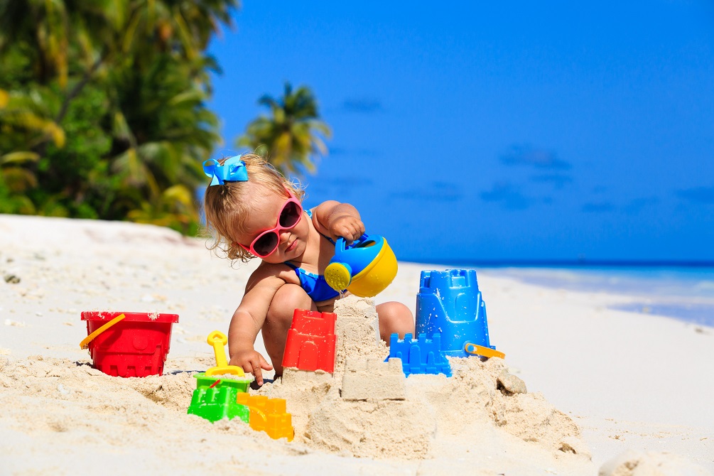 Cute little girl playing with sand