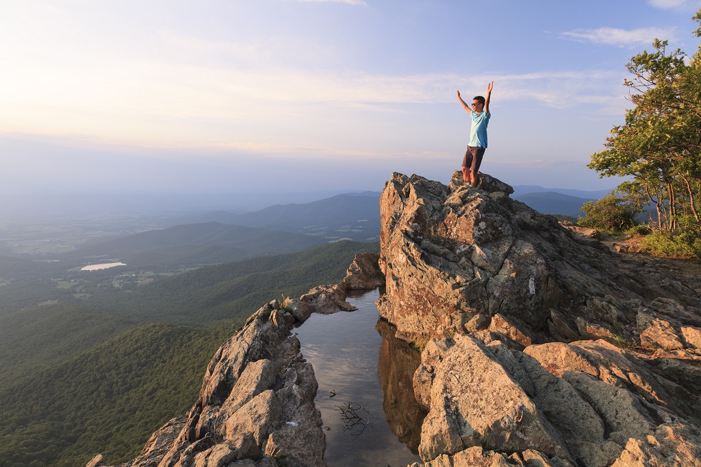 Teenager on the edge of a cliff