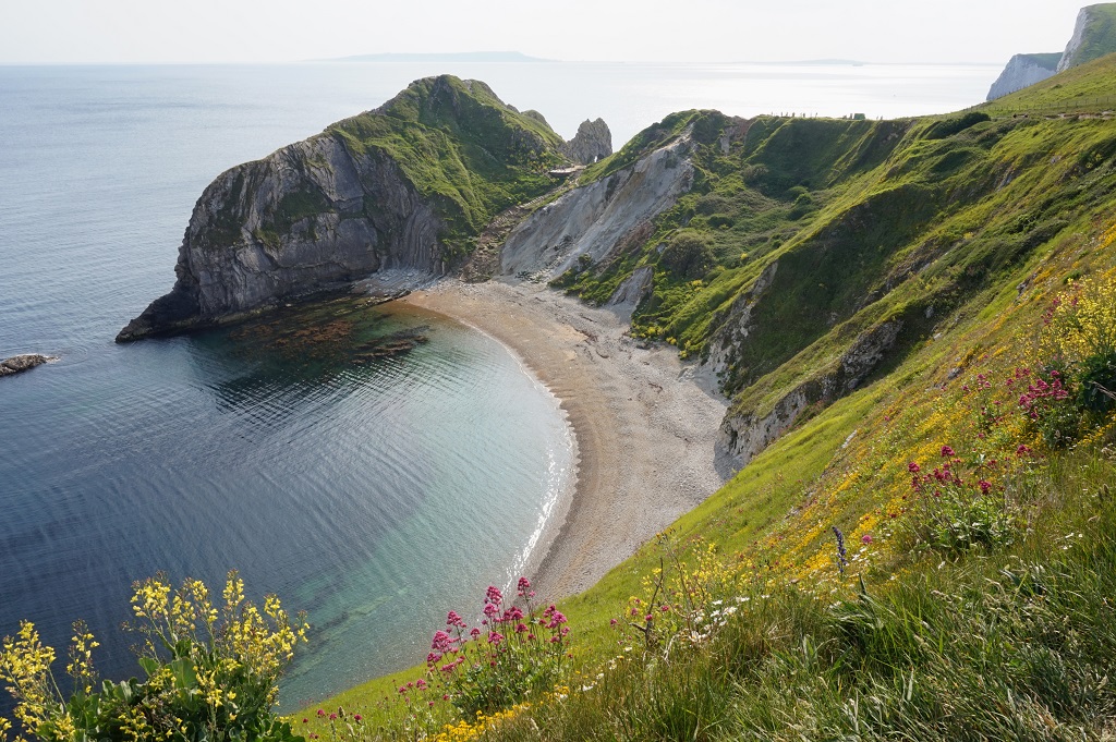 Beautiful view of the green mountains and hills near the sea in Durdle Door, Wareham, UK